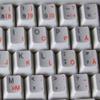 Swedish - Finnish Keyboard Stickers with Orange Lettering ON Transparent Background view 4