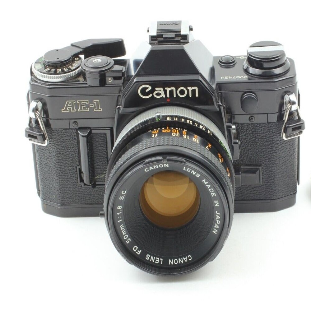 Canon AE-1 35mm SLR Film Manual Focus Camera (Black) with 50MM Canon FD Mount Lens. (Renewed)