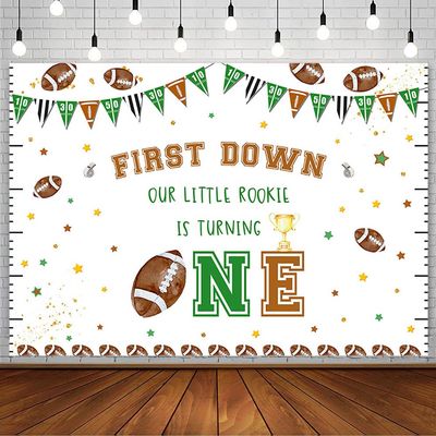 AIBIIN 8x6ft Football 1st Birthday Backdrop Our Little Rookie is Turning One Photography Background Football Party Decorations First Down Newborn Cake Table Banner Photo Studio Prop